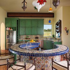 a kitchen with green cabinets and an island in the middle