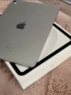 an apple ipad is sitting on top of a box and it's still in its packaging