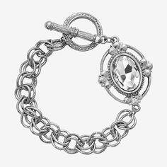 Shine bright in this on-trend toggle bracelet. Vintage style floral motif pendant showcases a simmering faceted oval lux crystal . This gorgeous bracelet adds subtle sparkle to any outfit.Circumference: 8 InchJewelry Closure: Toggle ClaspStone Cut: OvalMetal Color: Silver ToneChain Length: 8 InchCare: Wipe CleanStone Type: 1 CrystalBracelet Type: Link BraceletsMetal: AlloyIs Beaded: NoCountry of Origin: Made in US Oval Metal Jewelry With Adjustable Chain, Elegant Metal Charm Bracelet With Toggle Clasp, Elegant Metal Crystal Bracelet With Lobster Clasp, Bracelets Chain, 1928 Jewelry, Toggle Bracelet, Watch Chain, Bracelet Vintage, Gorgeous Bracelet