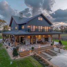 a large house sitting on top of a lush green field