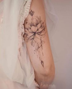 a woman's arm with a flower tattoo on the left side of her body