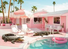 two alligators are sitting in the pool next to a house with pink walls and palm trees