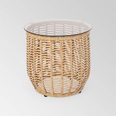 a round wicker table with glass top