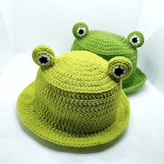 two crocheted hats with eyes on them