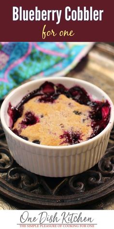 blueberry cobbler in a white dish with text overlay that reads, how to make blueberry cobbler for one