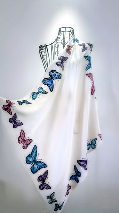 "Hi! This is 100% pure silk and hand painted one-of-a-kind piece of wearable art. The silk scarf \"Elegant Butterflies\" represent set of detailed drawn artistic butterflies in different colors. The dimensions of this medium silk scarf are 70m x 70 cm, approx.28\" x 28\". The scarf is with hand sewn hem. The silk is very beautiful 100% natural and delicate satin silk. Colors are set by professional steaming process, so the silk dye bonds with the silk fibres at the molecular level. Colors are permanently fixed and sun tolerant - they will never fade. This scarf is made to order and I'll need approx. 5- 10 days to complete it and steam fix the colors permanently, so they will never fade. Because this scarf is entirely free hand painted so slightly differences may occur - but this will make Saree Painting, Butterfly Scarf, Hand Painted Dress, Fabric Paint Designs, Hand Painted Scarves, Butterfly Butterfly, Hand Painted Fabric, Painted Scarf, Silk Scarf Painting