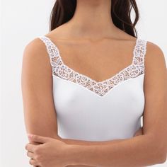 Elevate Your Basics With This Perfect White Tank. Wear This With Jeans, Leggings And A Blazed, Your Favorite Sweater Or A Skirt. The Lace Helps Upgrade Any Of Your Closet Staples. Runs True To Size. White Stretch Camisole, White Sleeveless Elastane Camisole, White Stretch Elastane Camisole, Elegant Elastane Camisole Top, White Elastane Camisole, White Fitted Elastane Camisole, Elegant White Tops With Delicate Straps, Elegant White Seamless Top, White Seamless Camisole