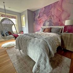 a bedroom with a hanging chair and bed