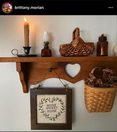 a shelf with some items on it and a basket hanging from the wall next to it