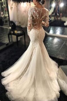 the back of a wedding dress with long sleeves and beading on it, is displayed in an instagram