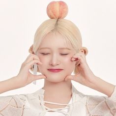 a woman holding her head in front of an apple on top of her head,