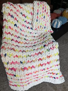 a crocheted blanket sitting on the floor