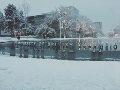 the university of british columbia sign is covered in snow