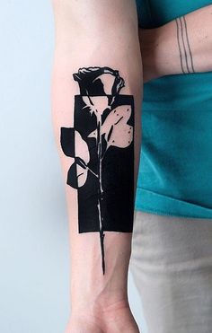 a woman's arm with a flower tattoo on it