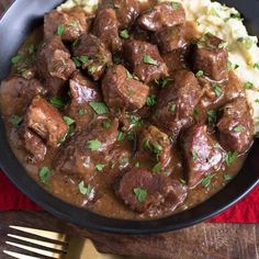 a bowl filled with meat and mashed potatoes