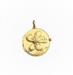 "This beautiful 14 Karat yellow gold \"Flower Locket\" pendant is embellished with a diamond of 0.02 ct. on the center and all handmade by Carolyn. Diamonds approx. 0.02 ct. weight Total weight of gold is 5 grams. Bale would accommodate approx. 1.5 - 2mm chain. Can be ordered in rose or white gold. 14K Yellow Gold 16\" long chain can be purchased separately for $80." Yellow Gold Diamond Medallion Jewelry, Heirloom Gold Jewelry With Single Diamond, Formal Round Jewelry With Flower Charm, Heirloom Flower Engraved Jewelry, Heirloom Flower-shaped Engraved Jewelry, Diamond Flower Charm Jewelry For Anniversary, Diamond Jewelry With Flower Charm For Anniversary, Yellow Gold Diamond Flower Jewelry, Gold Flower-shaped Jewelry With Single Cut Diamonds