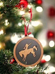 a wooden ornament hanging from a christmas tree