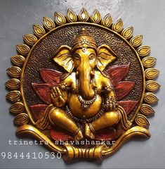 an elephant statue is sitting in the middle of a gold frame