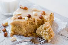 a piece of cake sitting on top of a table next to a glass of milk