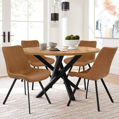 a dining room table with four chairs around it