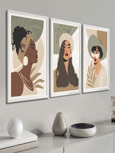 three framed art prints on the wall above a dresser