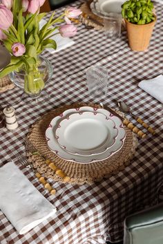 the table is set with dishes and place settings