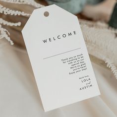 a white welcome card sitting on top of a table