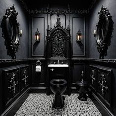 a black and white bathroom with fancy fixtures