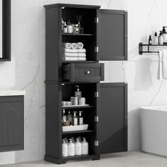 a bathroom cabinet with lots of white towels and toiletries on it's shelves