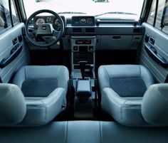 the interior of a vehicle with blue leather seats