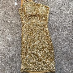 Worn For 2 Hours. One Strap And Side Zipper. This Dress Has Never Been Altered. Gold Sequin Tank Dress, Gold Sleeveless Mini Dress With Contrast Sequin, Champagne V-neck Mini Dress With Sequins, Gold Sequin Shorts, Gold Embellished Sequin V-neck Dress, Glamorous Sequin Mini Dress By Forever 21, Sequin Short Dress, Gold Sequin, Side Zipper