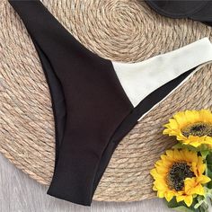 Indulge in timeless elegance with our Black and White Wonder Push-Up Bikini. This classic beach style offers a perfect balance of sophistication and allure. Crafted with durable and comfortable nylon and Terylene, and featuring a solid pattern, it offers a touch of simplicity and versatility. The padded cups and wire-free design ensure a comfortable fit that flatters your figure. Complete your beach or poolside ensemble with the low waist bottom. Designed by Thekittenpark Black Nylon Beach Bottoms, Elegant Black Swimwear For Beach Party, Fitted Nylon Bottoms For Beach Party, Chic Nylon Beach Bottoms, Chic Nylon Bottoms For The Beach, Nylon Brief Swimwear For Summer, Elegant Nylon Swimwear For Sunbathing, Chic White Nylon Swimwear, Chic Beach Brief Bottoms