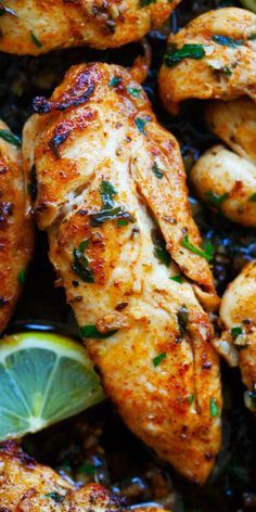 grilled chicken with lemons and herbs in a skillet, ready to be eaten