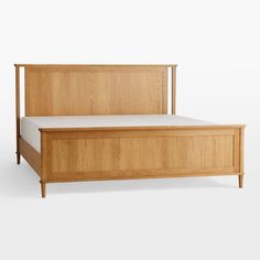 the bed frame is made from wood and has white sheets on it, with no headboard