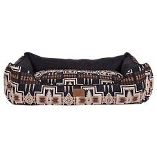 the dog bed is black and brown with an ethnic pattern