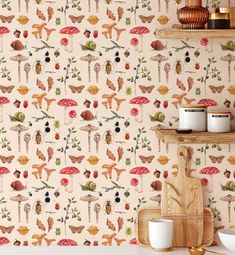 a wallpaper with mushrooms and birds on it in a kitchen, next to a wooden shelf