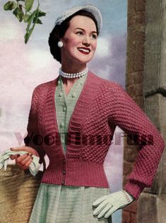 a woman wearing a pink sweater and white gloves