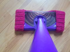 a purple and pink vacuum on the floor