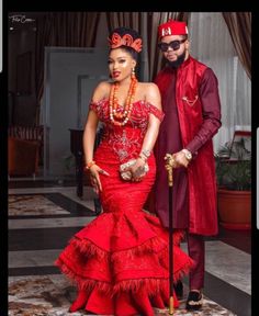 a man and woman dressed in red standing next to each other