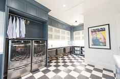 a large laundry room with checkered flooring and gray washer and dryer