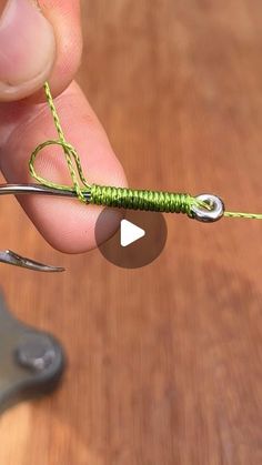 a person is holding a tiny green fishing lure