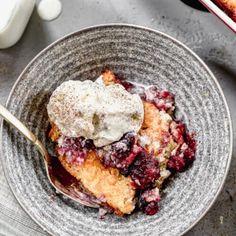 a bowl filled with fruit and ice cream on top of a table