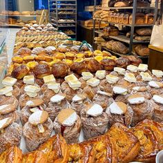 many different types of breads and pastries on display