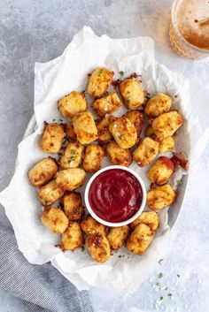 tater tots with ketchup on a plate