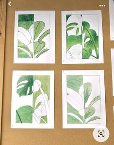 four green and white paintings on a brown surface