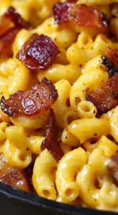 a close up view of some pasta with bacon