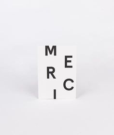 a piece of paper with the word merci on it in black and white letters