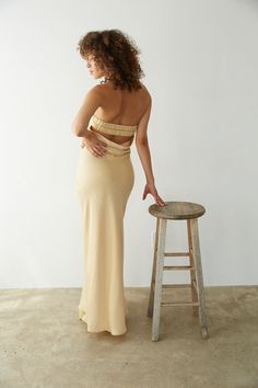 Stay RSVP ready in the Jayla Strapless Open Back Maxi Dress! This maxi dress features a strapless neckline, open back detail, and satin finish. Available in Honey; pair with some chic heels to polish off the fantasy!Details: Shell: 100% Polyester Lining: 95% Polyester, 5% Spandex Fully Lined Elastic Back Strap Silicone Grips Some Stretch Hand Wash in Cold Water/ Line Dry