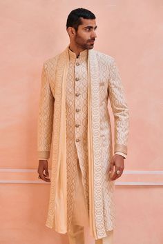 Beige silk sherwani with resham embroidered geometric pattern. Comes with trouser, a kurta and a pre-pleated stole.
Components: 4
Pattern: Embroidered
Type Of Work: Resham
Neckline: Mandarin collar
Sleeve Type: Full
Fabric: 100% Silk
Color: Beige
Other Details: 
Closure : Front buttons
Occasion: Wedding - Aza Fashions Embroidered Sherwani, Beige Silk, Embroidered Silk, Mandarin Collar, Helix, Aza Fashion, Sleeve Type, Types Of Sleeves, Geometric Pattern