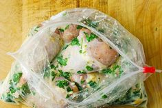 a plastic bag filled with food on top of a wooden table